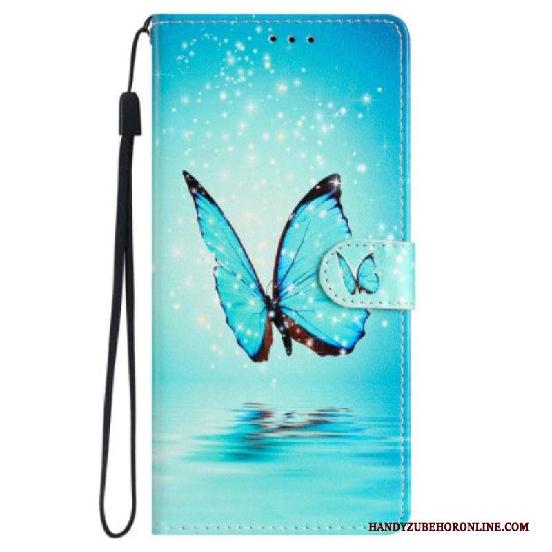 Custodia in pelle iPhone 15 Farfalla Blu In Volo Con Cinturino